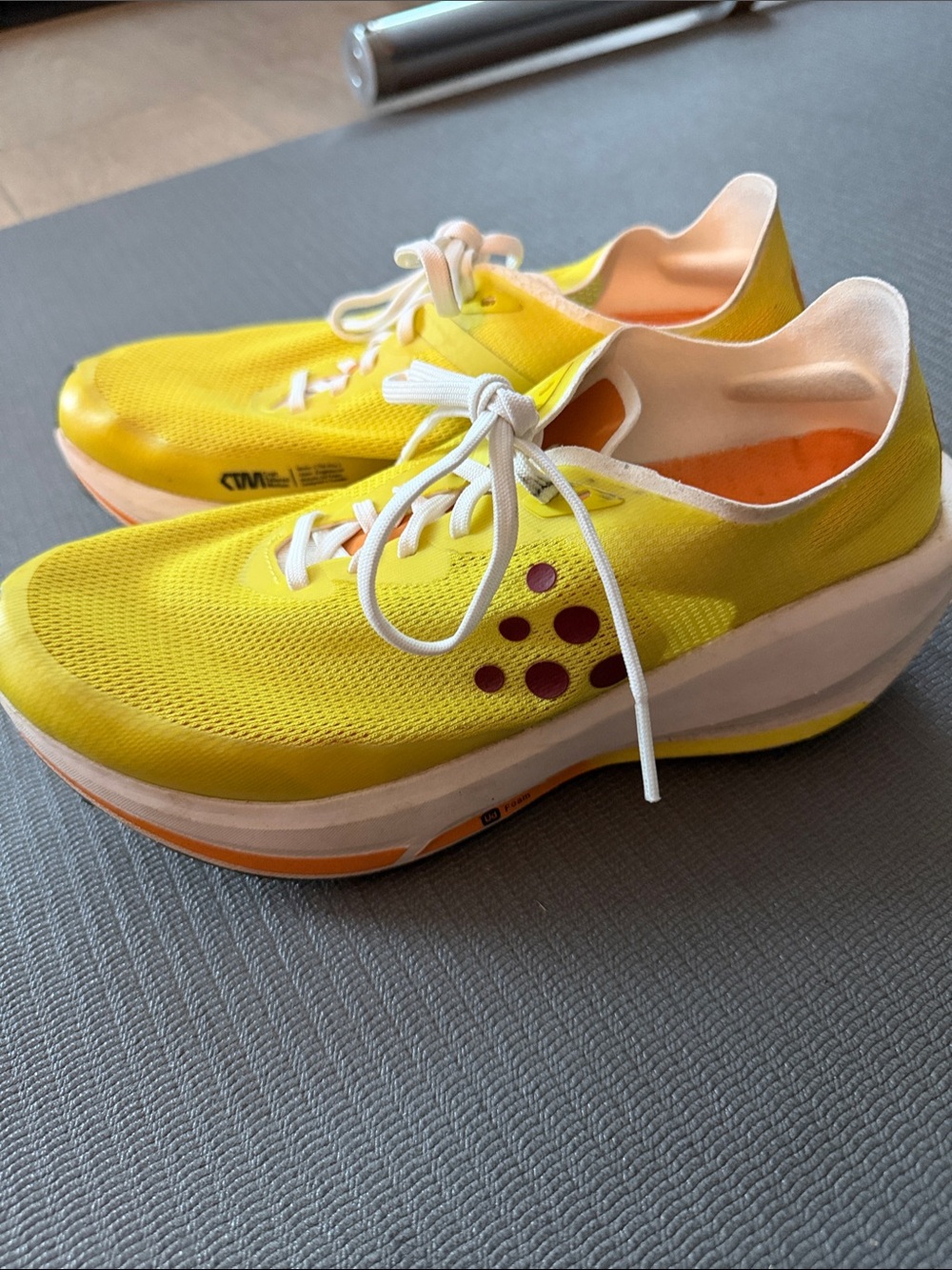 Craft Women's Yellow Athletic Running Shoes with Purple Accents.